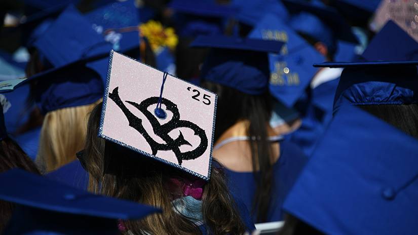 A Santa Monica College graduate’s mortarboard showcases her transfer destination. Campaign for College Opportunity has named SMC a 2025 Pathway Champion in the “Pathway Champion of Transfer” category. Alongside SMC, Victor Valley College and Mira Costa College were recognized for “campuswide growth in ADTs” defined as “top community colleges supporting the largest growth in the number of students earning Associate Degrees for Transfer between the 2022–23 and the 2023–24 academic years.” (Photo Credit: Jonathan Ng / Santa Monica College)