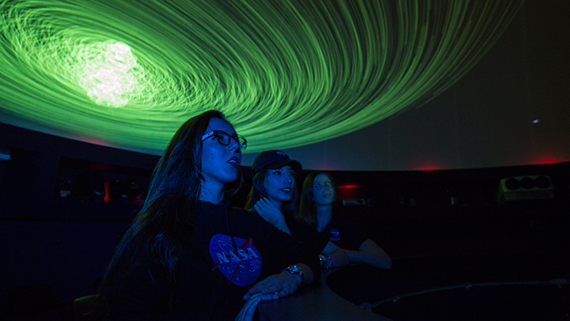 Visitors to the Planetarium seeing the wonders of the Universe