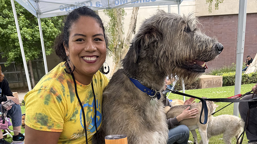 Julyssa with therapy dogs at a campus resource fair