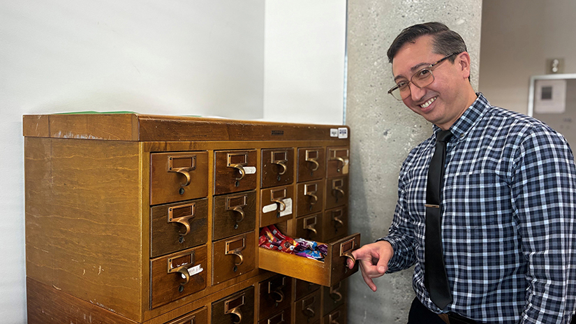 Walter with the repurposed card catalog holder in his office